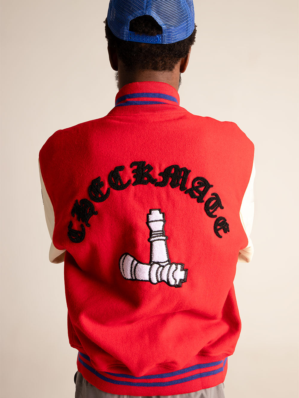 Model wears Checkmate Anywear Varsity on Red rear pose