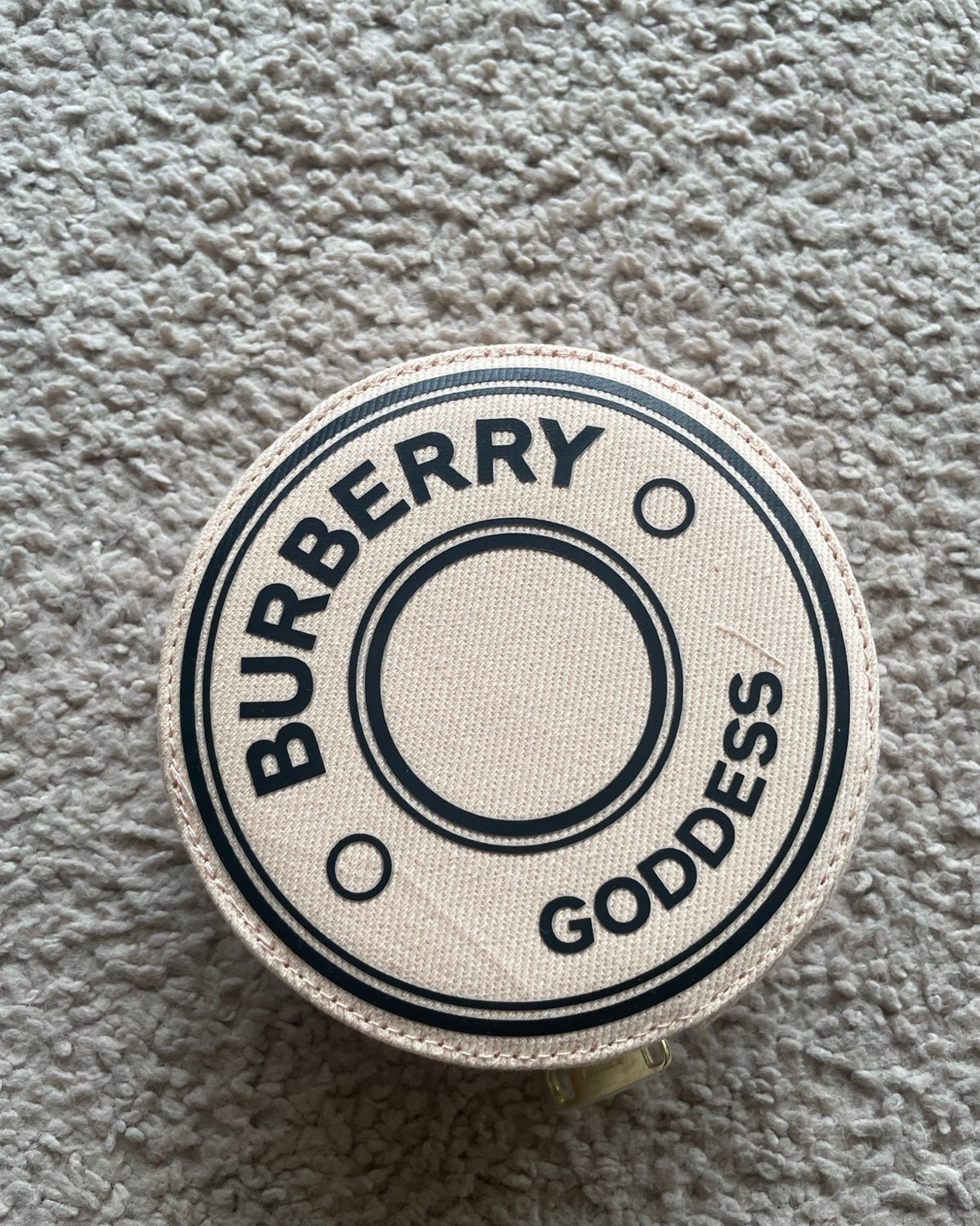 Burberry Goddess product on a textured cream colored surface