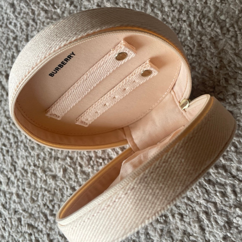 Beige make up case on a textured surface