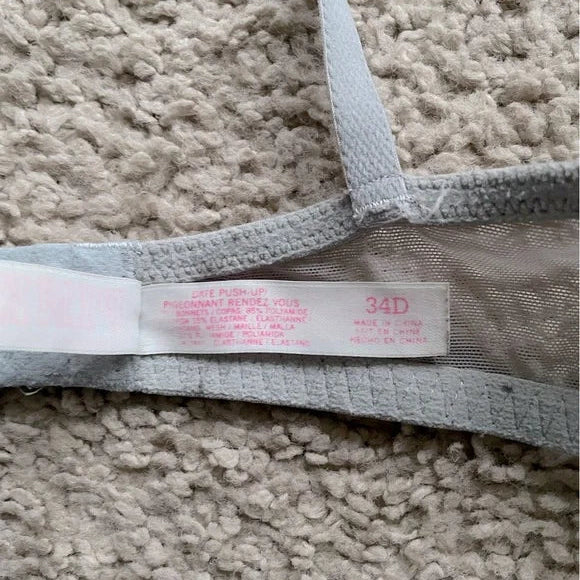Close-up of a lace garment with a label on a textured surface
