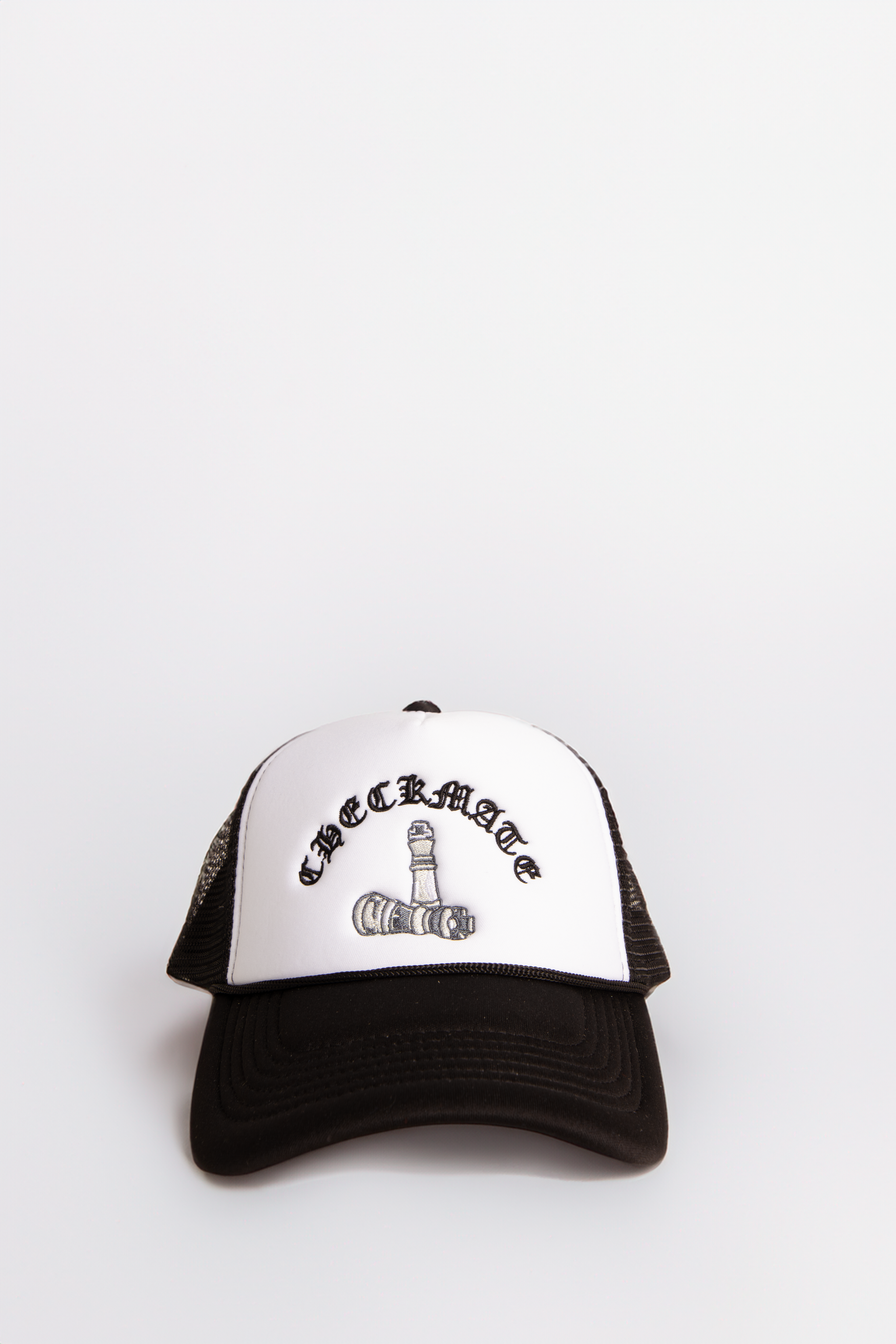 Black and white cap with text on a light neutral background