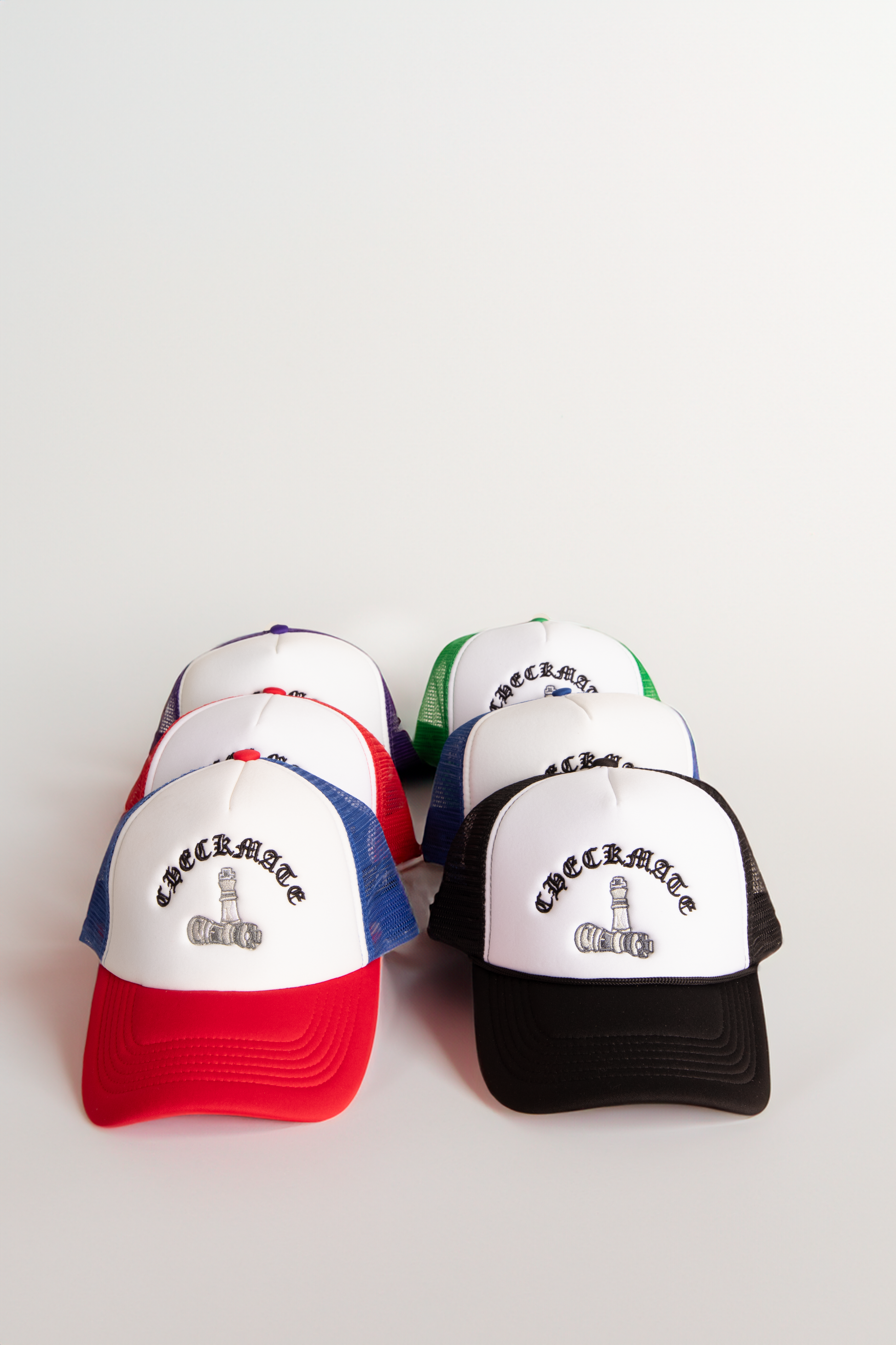 Collection of Checkmate Anywear colorful trucker hats with text on a white background