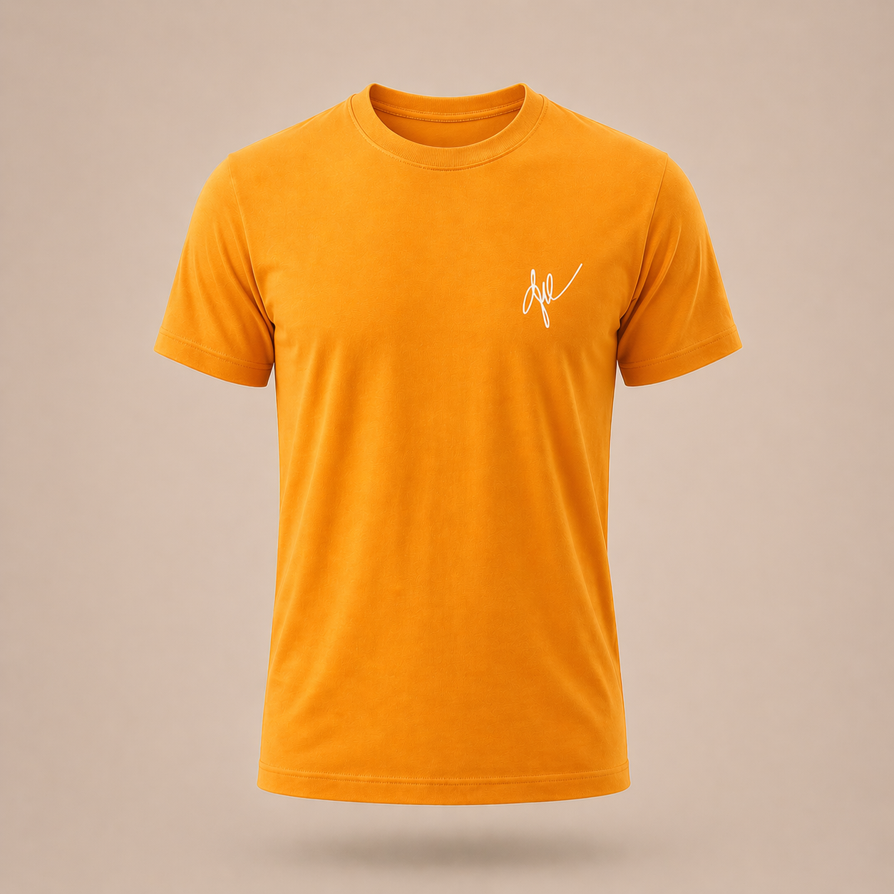 Yellow-orange t-shirt with a small white signature logo on a beige background