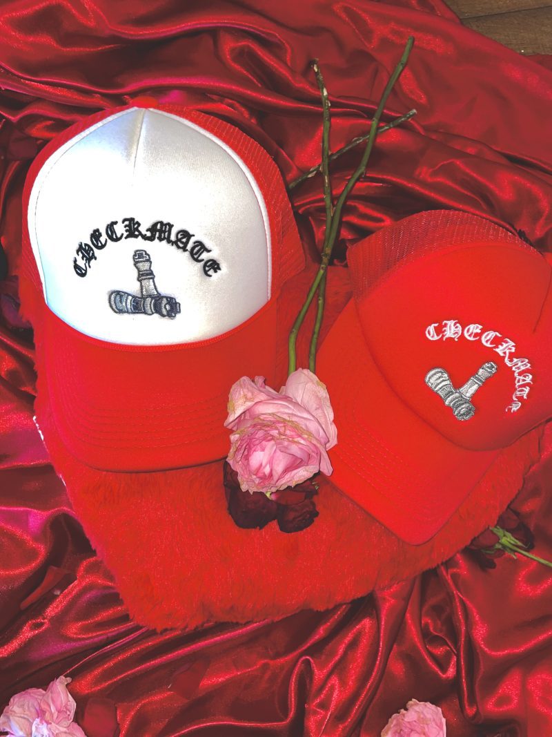 Checkmate Anywear Red Trucker hat with White Embroidery, Varsity Jacket, and flowers